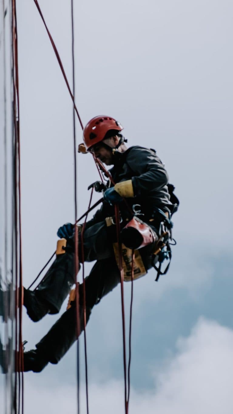 Aukštalipis dirba prie daugiabučio fasado